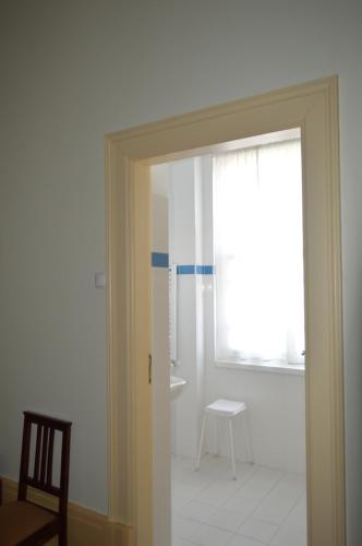 a door to a room with a window and a chair at Casa Vermelha in Vila Nova de Foz Coa