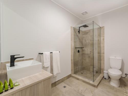 a bathroom with a shower and a sink and a toilet at Nightcap at Belgian Beer Cafe in Perth