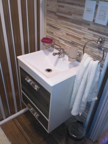 a bathroom with a white sink and a mirror at Playa, bosque y lago in Montevideo