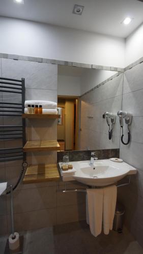 a bathroom with a sink and a mirror at Apartamenty Efekt 72 in Gdynia