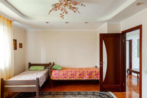 a bedroom with two beds and a chandelier at Hostel Astana in Astana