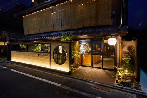 a store front with a lit up window at night at Rinn Gion Kenninji in Kyoto