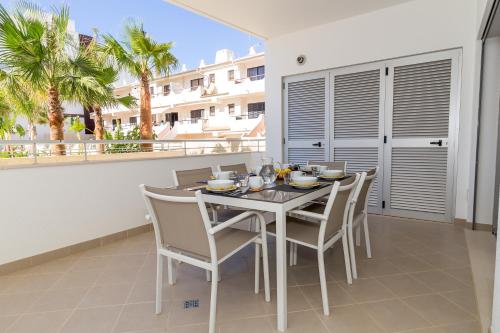 
a kitchen with a table, chairs and a table cloth at Beach Condominium in Lagos
