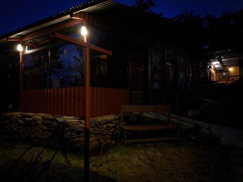 a house with lights on the side of it at night at Greemount Hotel in Monteverde Costa Rica