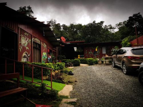 a car parked in front of a house with graffiti at Greemount Hotel in Monteverde Costa Rica