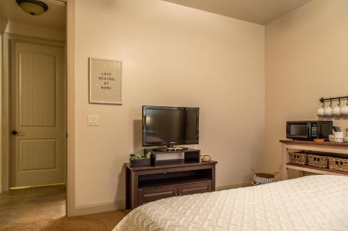 een slaapkamer met een bed en een flatscreen-tv bij Hurricane Hill Home in Hurricane