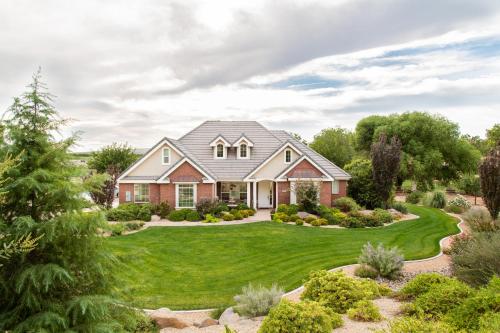 a house with a yard with green grass at Hurricane Hill Home in Hurricane