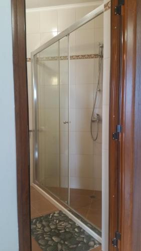 a shower with a glass door in a bathroom at GENIKO Apartments in Pomorie