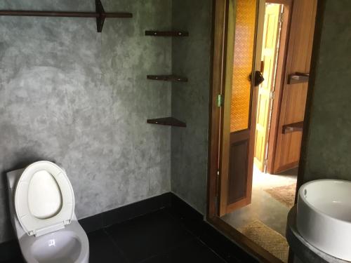 a bathroom with a toilet and a sink at Chabalay Resort in Koh Tao