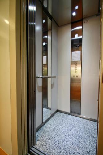 a glass door to a elevator in a building at Alpujarra Secret by eme hoteles in Órgiva