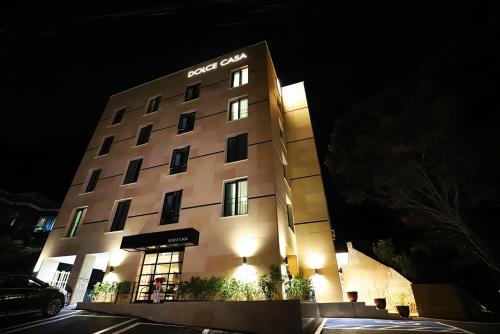 a hotel building with a sign on it at night at Namyangju Bukhangang dolcecasa hotel in Namyangju