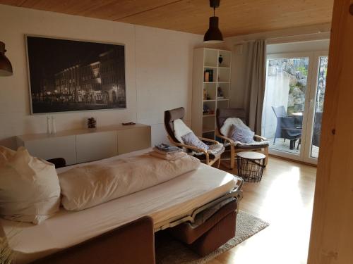 um quarto com uma cama grande e uma sala de estar em Ferienwohnung TREIBGUT em Uhldingen-Mühlhofen