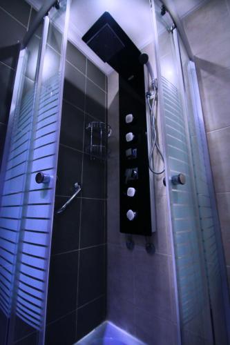 a bathroom with a shower with a sink and a tub at City Rose Hotel Suites in Amman