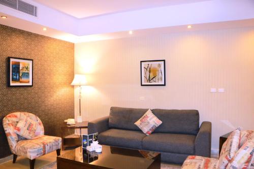 a living room with a couch and a chair at City Rose Hotel Suites in Amman
