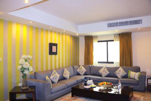 a living room with a couch and a table at City Rose Hotel Suites in Amman