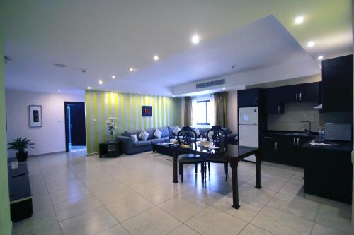 a living room with a couch and a table at City Rose Hotel Suites in Amman