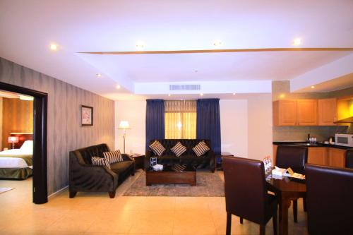 a living room with a couch and a bed at City Rose Hotel Suites in Amman