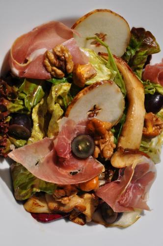 a salad with ham and other vegetables on a plate at Hotel Tipotsch in Stumm