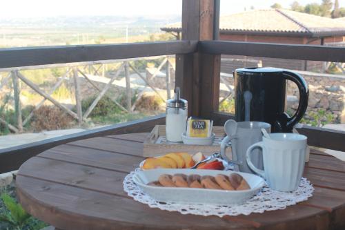 a table with a tray of food and coffee on it at Villaggio San Demetrio in Carlentini