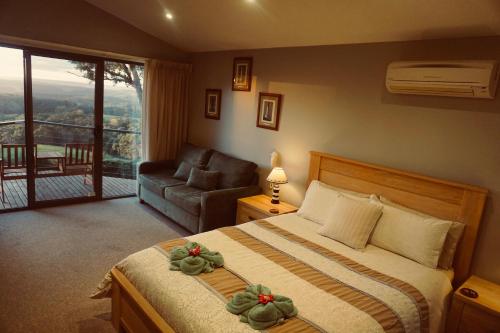 a hotel room with a bed and a balcony at Southern Anchorage Retreat in Wattle Hill