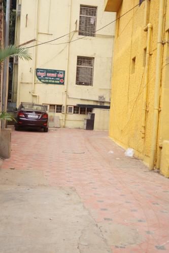 a car parked in front of a building at Hotel Surya Residency Majestic in Bengaluru