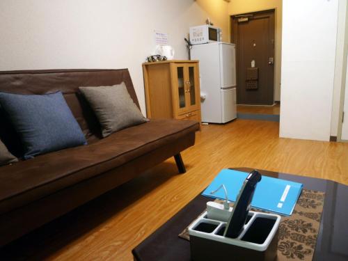 a living room with a couch and a table at Free bike & free WIFI 203 Take it easy in Kyoto