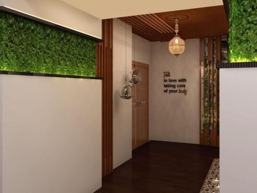 a hallway with green plants on the walls at Romance Alexandria Hotel in Alexandria