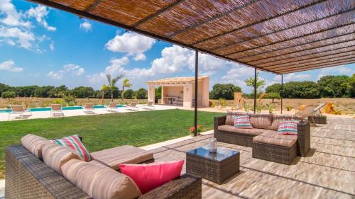 an outdoor patio with couches and a table at Son Bennassar 2.0 in Felanitx