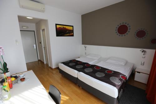 una piccola camera da letto con un letto e un tavolo di Hotel Draganic a Draganići