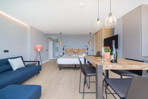 a living room with a blue couch and a bed at La Marine in Melenara