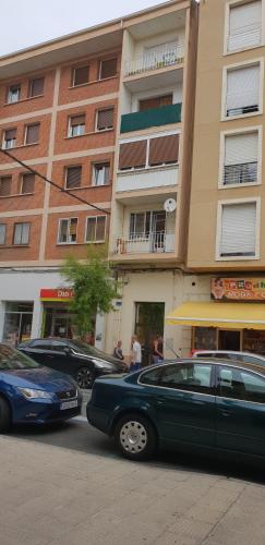 two cars parked in front of a building at Apartamento La Ruta Del Vino in Haro
