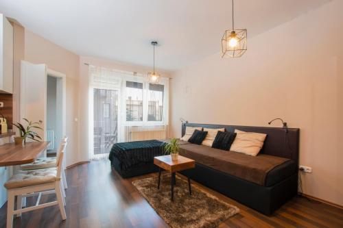 a living room with a couch and a table at Főtér Apartman Kaposvár in Kaposvár