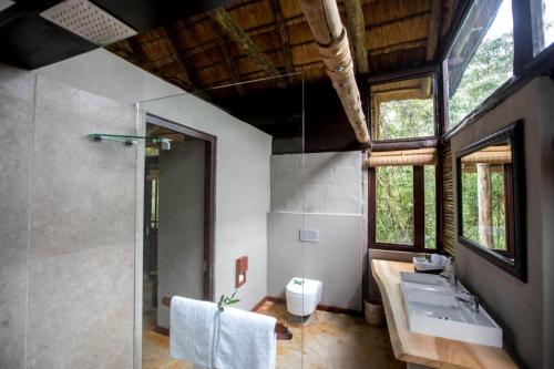 a bathroom with a sink and a shower at Royal Thonga Safari Lodge in Sihangwane