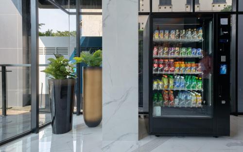 a vending machine filled with lots of drinks at Juno Tanah Abang Jakarta in Jakarta