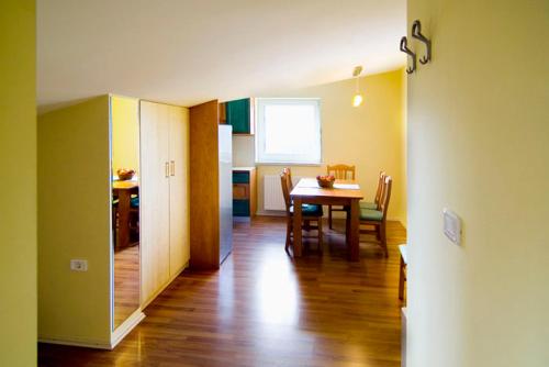 a kitchen and dining room with a table and chairs at Hiša posebne Sorte in Kodreti