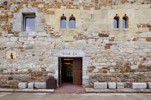 a stone building with a door with a sign on it at Heredad de Unanue in Donostia-San Sebastián