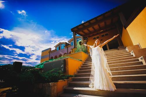 a woman in a dress standing on some stairs at Hiša posebne Sorte in Kodreti