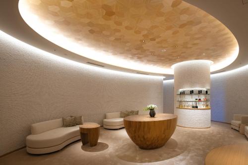 a living room with a large circular ceiling at Hyatt Regency Seragaki Island Okinawa in Onna