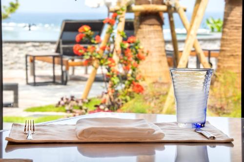 a table with a napkin and a glass of water at Hyatt Regency Seragaki Island Okinawa in Onna