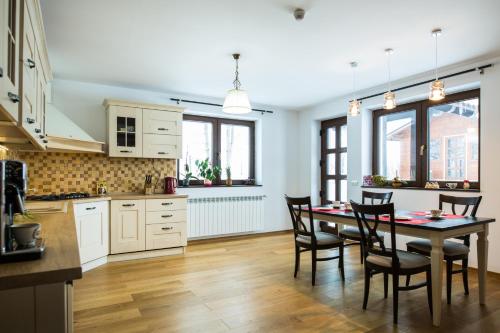 a kitchen and dining room with a table and chairs at Bran Monte Crai Chalet in Bran