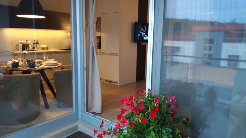 a view of a living room with a table and a window at Apartment Holata 401 in Hradec Králové