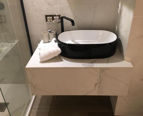 a bathroom with a black and white sink on a counter at Abalú Boutique & Design Hotel in Madrid