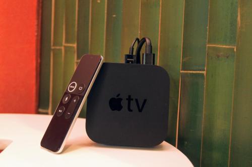 an apple remote control sitting on top of a table at Family house (private house) in Osaka