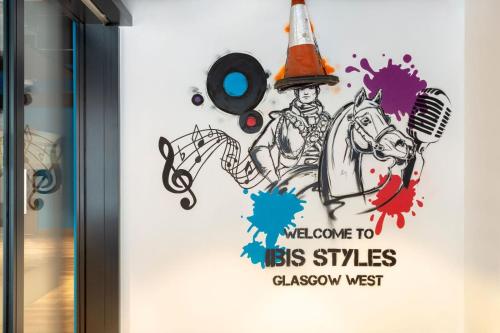 a sign for a show with a clown riding a horse at ibis Styles Glasgow Central in Glasgow