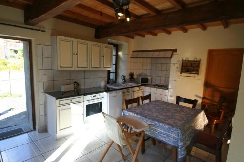 a kitchen with a table and a table and chairs at Mas Manyaques in Le Tech
