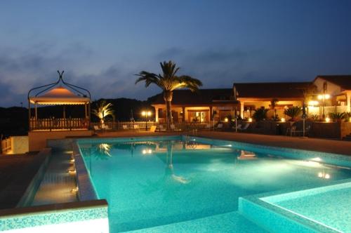 a large swimming pool at night with a gazebo at Corte In Fiore in Ardea