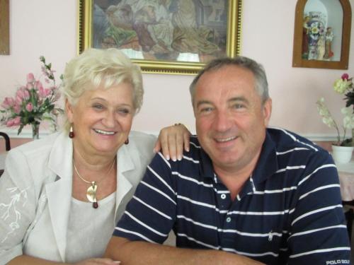 a man and a woman sitting on a couch at Hotel Panorama in Mosonmagyaróvár