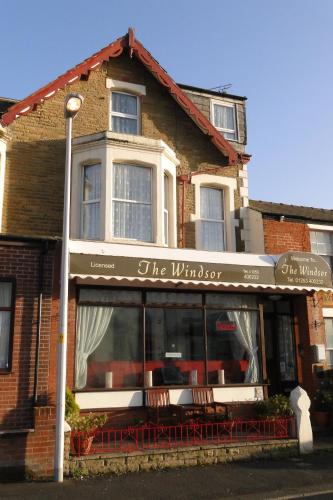 a building with a sign for the window of a restaurant at Windsor Hotel in Blackpool