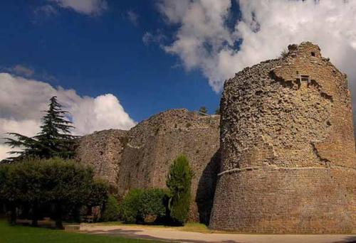 a large stone building with trees and a tree at Casa Tabor in Ariano Irpino