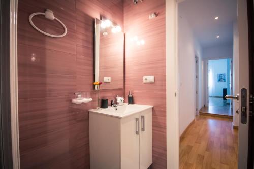 a bathroom with a sink and a mirror at Holidays2Malaga Heredia 3 bedroom opposite Malaga Port in Málaga